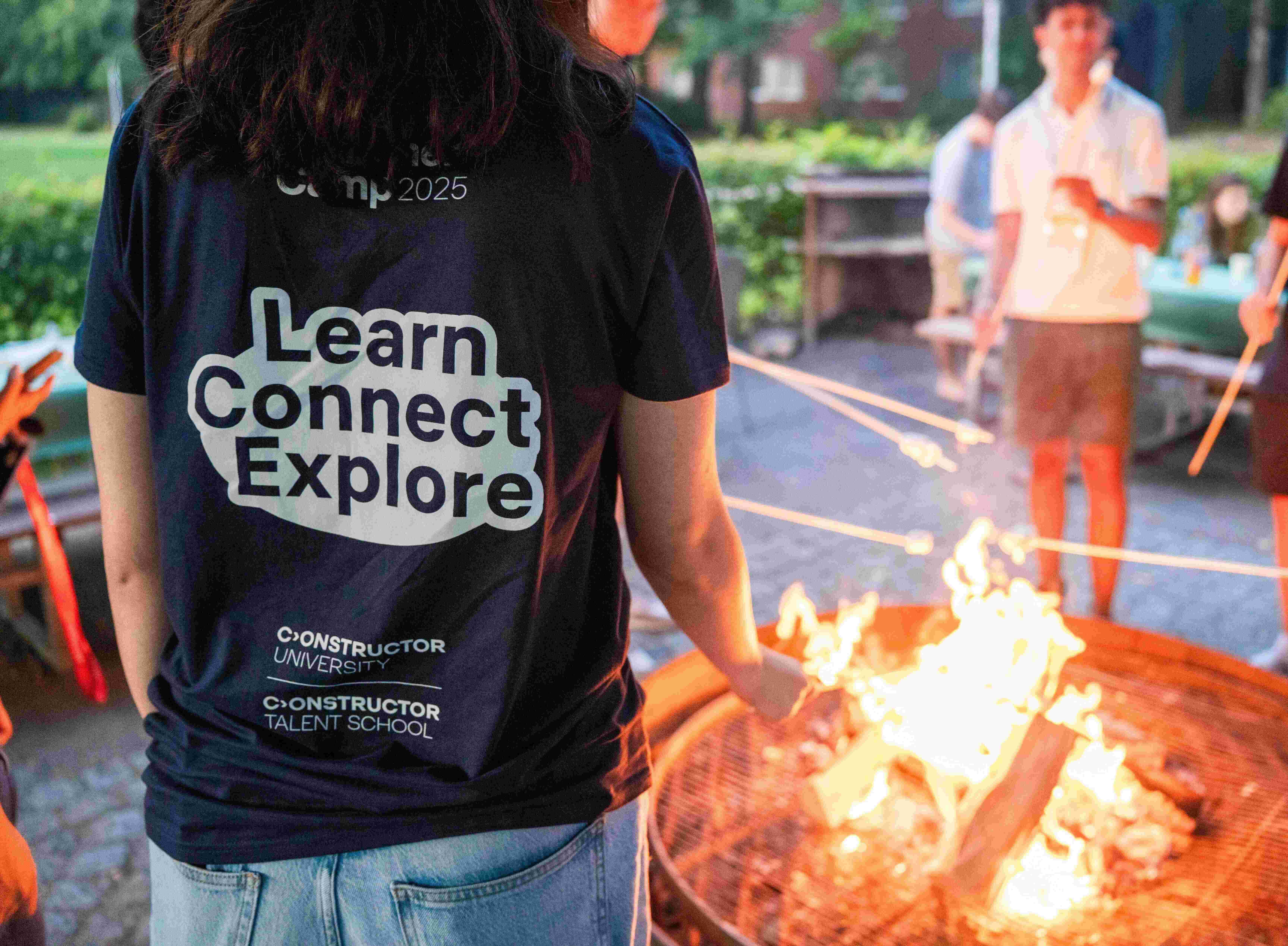 Students gathered around Constructor Summer Camp Bonfire.