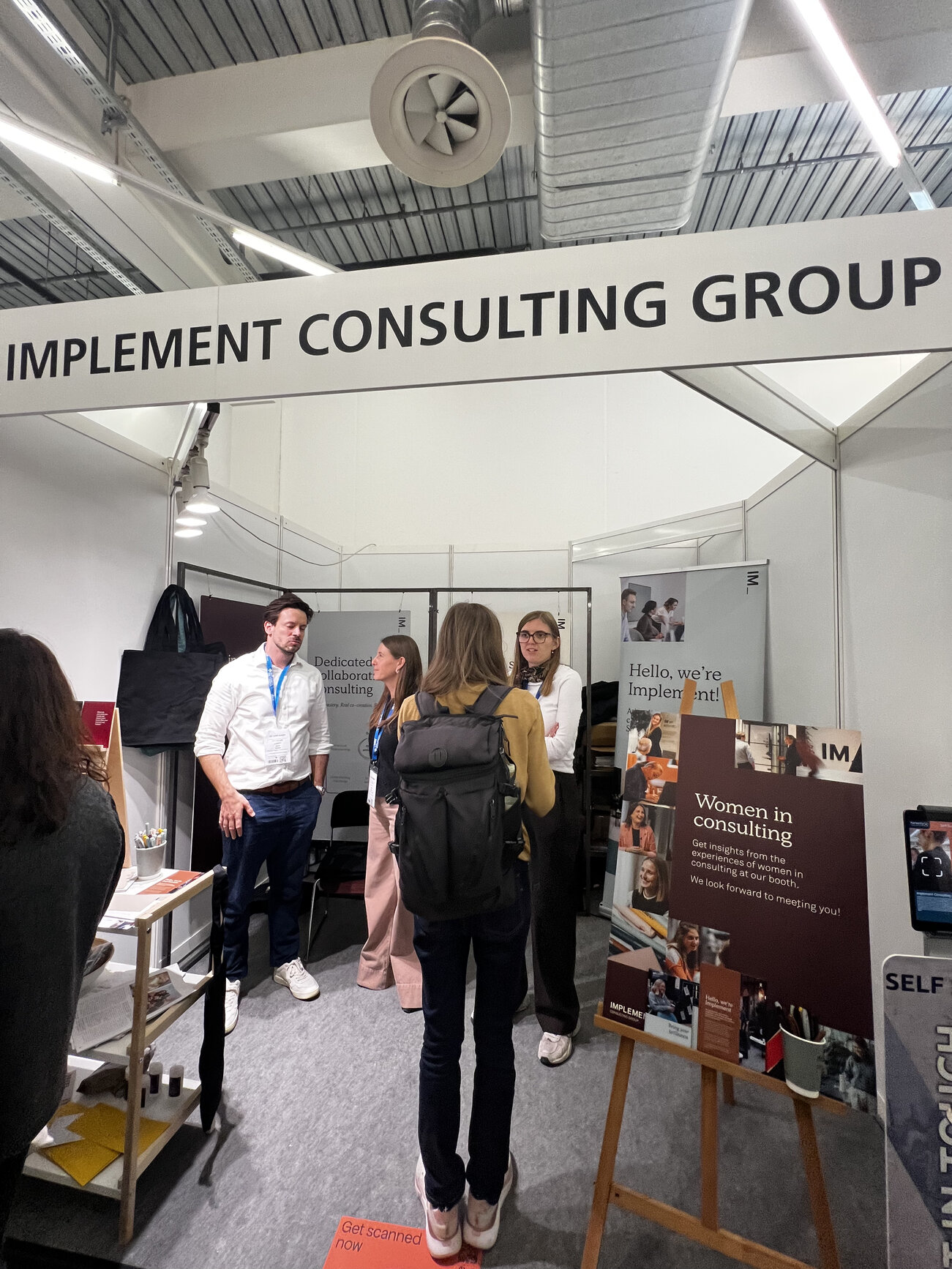 Networking at Implement Consulting Group booth