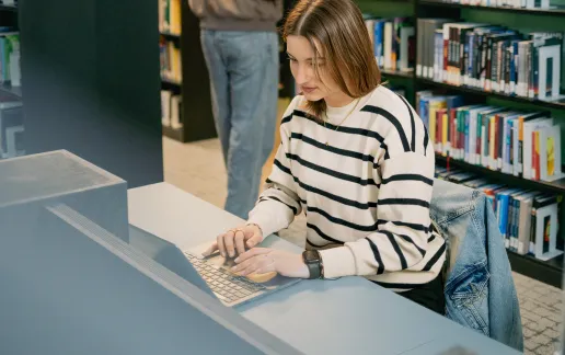 Student typing on a laptop