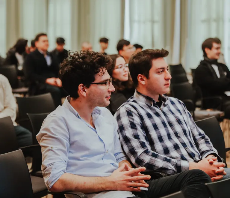 Students sitting in the Conference Hall listening to a presentation