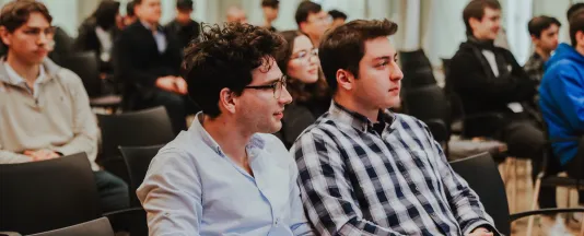 Students sitting in the Conference Hall listening to a presentation