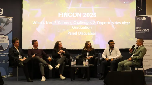 Panelists discussing at the FinCon