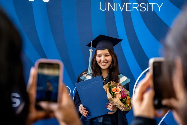 Female Student of Constructor University with her diploma
