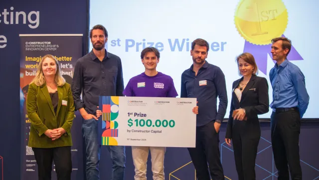 A winning team and organizers pose with a first-prize cheque entrepreneurship event