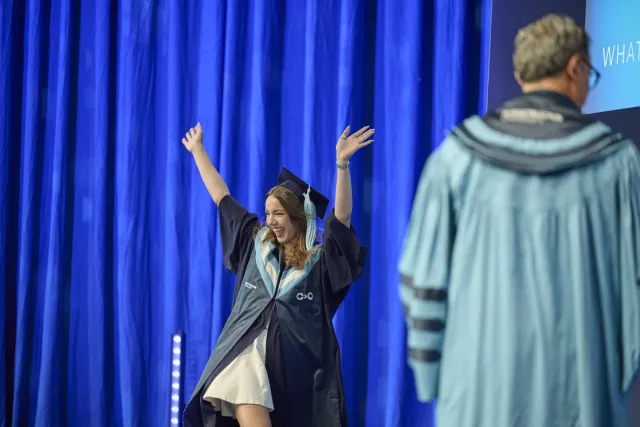 A smiling Constructor University graduate at graduation ceremony