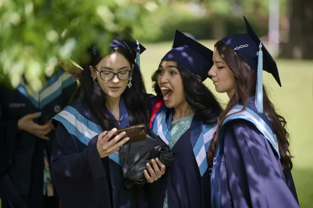 Three Constructor University graduates celebrating together in their graduation